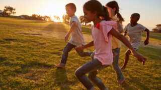 four-children-running-barefoot-in-a-park-2023-11-27-05-03-37-utc-resized.jpg